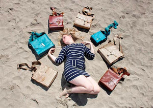 Coterie Leather Bags - girl with bag collection on beach